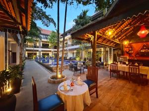 a restaurant with a table and chairs and a pool at Emerald Angkor Siem Reap in Siem Reap +106 photos