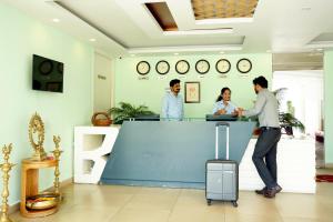 a group of people standing at a counter in a store at BigStay Apart Hotel in Tada +59 photos