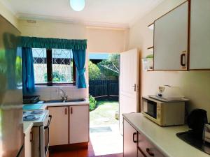 a kitchen with a sink and a microwave at All the Tides - Rip Tide in Margate
