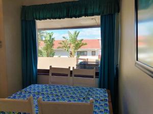 a bedroom with a table and chairs and a window at All the Tides - Rip Tide in Margate +16 photos