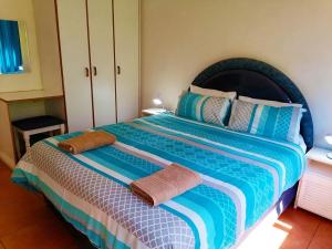 a bedroom with a large bed with towels on it at All the Tides - Rip Tide in Margate