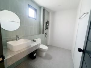a bathroom with a sink and a toilet and a mirror at Pool villa Cream Darin in Ban Hua Phrong
