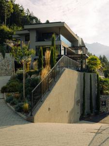 a house with a staircase in front of it at Culinaria living in Tirolo