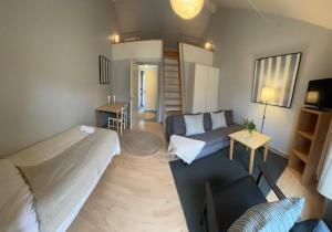 a bedroom with a bed and a couch and a living room at Sankt Helene Tisvildeleje in Tisvildeleje