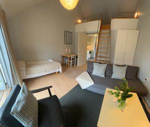 a living room with a couch and a bunk bed at Sankt Helene Tisvildeleje in Tisvildeleje