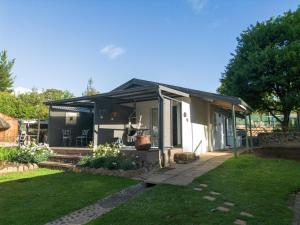 a small house with a black roof at Meander Stay Clarens in Clarens