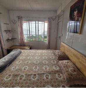 a bedroom with a large bed with a rug on it at Green Discovery B&B Tamarind Falls 7 Cascades in Henrietta