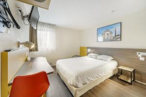 a hotel room with a bed and a red chair at Comfort Hotel Lille Lomme in Lomme +23 photos
