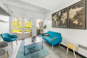 a living room with a blue couch and chairs at Comfort Hotel Lille Lomme in Lomme