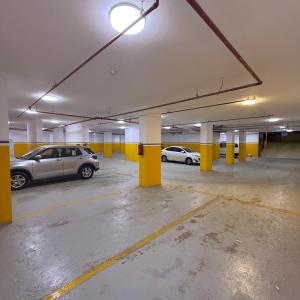 a parking garage with two cars parked in it at فندق سويت فيو in Al‘Āriḑah