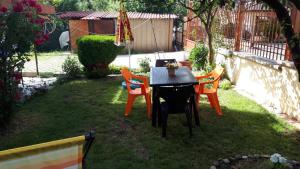 a table and four chairs in a yard at Guest House Blisten in Sofia