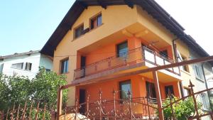 a yellow and orange building with a balcony at Guest House Blisten in Sofia