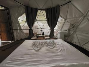 a bedroom with a large bed in a tent at สะปันฮิลล์ Sapan Hill in Ban Huai Ti