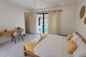 a bedroom with a bed with a stuffed animal on it at Gatch Villa in Unawatuna +67 photos