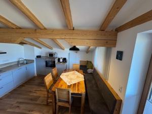 a kitchen and dining room with a wooden table and chairs at Ferienwohnung Garber in Uderns +74 photos