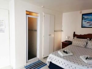 a bedroom with a bed and a sliding glass door at Boathouse Bed & Biscuit - Lower Deck in Margate