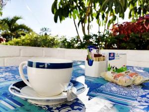 a coffee cup on a plate on a table at Boathouse Bed & Biscuit - Lower Deck in Margate