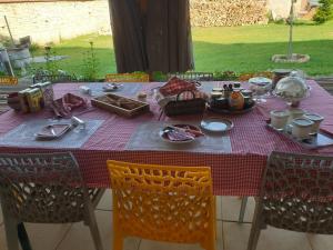 a table with a purple table cloth on it with chairs at La ferme de Tart in Verdonnet +20 photos
