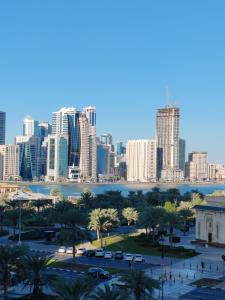 a view of the city of dubai with buildings at King bed sea view in Sharjah +42 photos