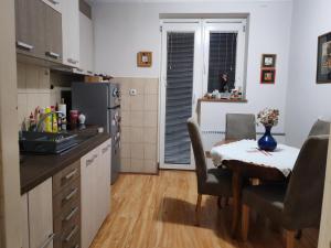 a kitchen with a table with chairs and a dining room at Signorina in Smederevo