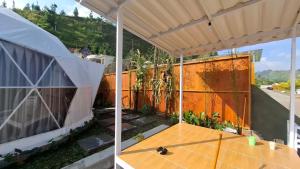 two views of a house with a tennis court in the yard at Sangkuriang 2 - Private Dome in Bandung