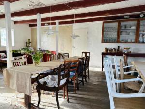 a dining room with a long table and chairs at Camønogaarden B&B, darksky cabins and events in Borre