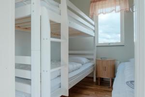 a bedroom with a bunk bed and a window at Gullbrannagården in Halmstad