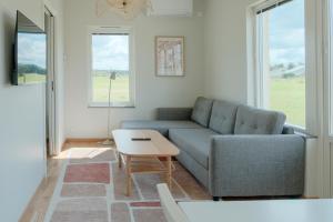 a living room with a couch and a table at Gullbrannagården in Halmstad
