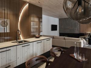 a kitchen and living room with a table and a couch at Andermatt Alpine Apartments in Andermatt +219 photos