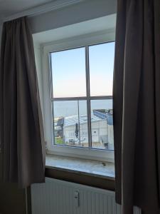 a window with a view of an airport at Fabelhaft am Meer in Timmendorfer Strand +5 photos