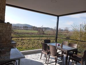 a table and chairs on a balcony with a view at Gelinkızı Apart in Kargınküre