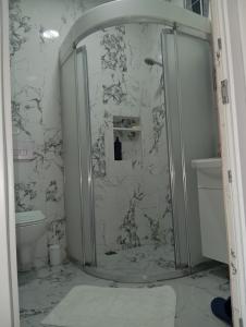 a shower with a glass door in a bathroom at Gelinkızı Apart in Kargınküre +45 photos