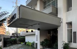 a white building with a balcony on a street at Hotel Tragopan in Dimāpur