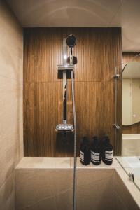 a glass shower in a bathroom with shoes on a shelf at DadamHotel in Suwon +49 photos