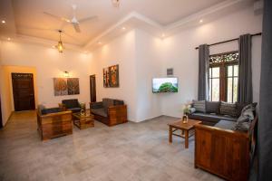 a living room with a couch and a table at The Lux Villa in Habaraduwa Central
