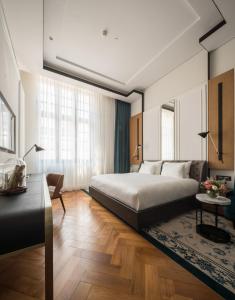 a bedroom with a large bed and a table at Yangon Excelsior in Yangon +75 photos