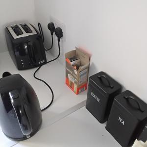 a desk with a computer monitor and a mouse and speakers at Rossaveal Farm in Leixlip