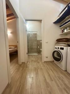 a laundry room with a washing machine and a washer at Locanda B&B Da Nati in Arba