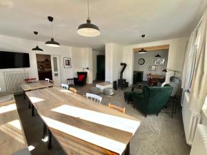 a living room with a large wooden table in it at Rychtrova bouda Benecko in Benecko