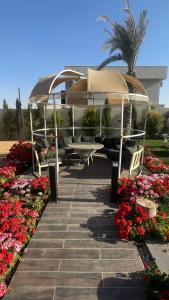a boat in a gazebo next to some flowers at Villa W2 in Amman