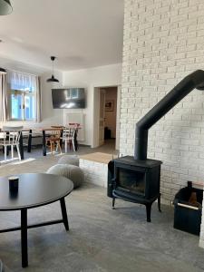 a living room with a fireplace and a table at Rychtrova bouda Benecko in Benecko