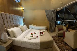 a hotel room with a bed with roses on it at RADISSON lUXURY RUM CAMP in Wadi Rum