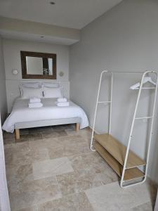 a bedroom with a white bed and a ladder at Château de la Follie Le Berne in Pierrefonds +5 photos