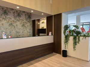 a waiting room with plants on the wall at Hotel Bel Sito Peschiera in Peschiera del Garda +108 photos