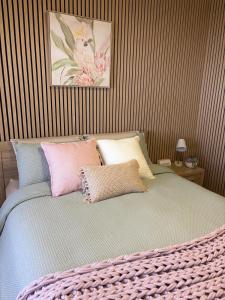 a bedroom with a bed with pillows on it at The Nest at Forest Lake - Stylish Guest Suite in Kangaroo Flat