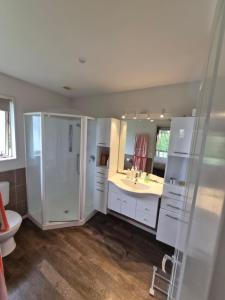 a bathroom with a shower and a sink and a toilet at Private Ensuite Room in Rolleston