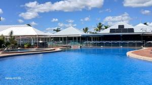 a large swimming pool in front of a building at Lousha Bach Dolphin Heads in Eimeo