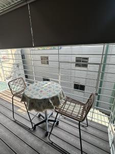 a table and two chairs on a deck with a table and chairs at Smile Home in Hanoi