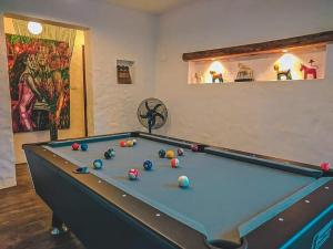 a pool table with balls on it in a room at Baantidnam in Ban Thung Tho