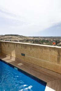 a swimming pool with a view of the desert at Ta Marija in Żebbuġ